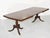This handsome vintage dining table features a classic silhouette and is crafted from solid wood. The table sits on two...