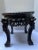 A single antique Chinese carved hardwood stand or table with inset marble top and four legs.