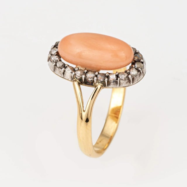 Stylish antique Victorian angel skin coral & diamond ring (circa 1880s to 1900s) crafted in 18 karat yellow gold. Cabochon...