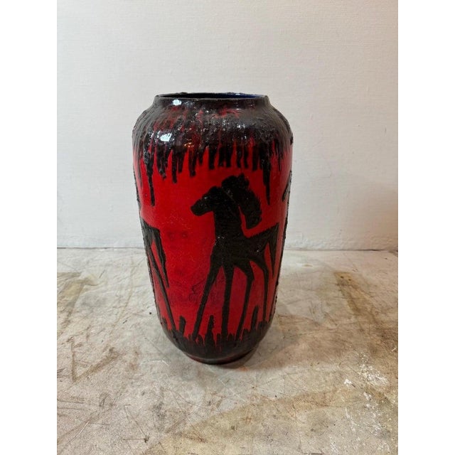 Crafted by Scheurich in western Germany, its bold red hue complements the striking dark brown and black equine motifs....