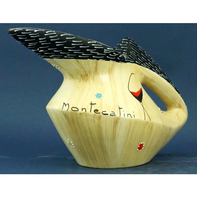 Item description: Majolica ceramic jug, entirely hand-decorated with the word "Montecatini" in the center, signed under...