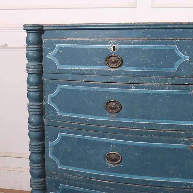 Early 19th C line decorated bowfront oak chest of drawers with turned columns. 1830 This piece is designed in the style of...
