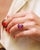 Vintage cocktail ring in 18 karat gold. Vintage ring adorned with a large faceted oval synthetic sapphire, purple in color...