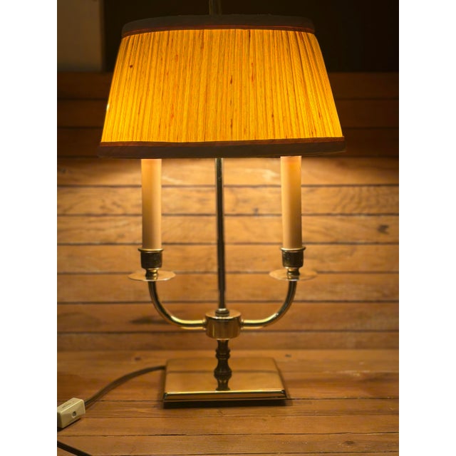 Classic French-inspired design meets timeless traditional style in this vintage bouillotte table lamp. The polished brass...