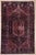 Antique hand-knotted rug from the Hamedan region of western Iran, featuring a large central hexagonal medallion enclosed...