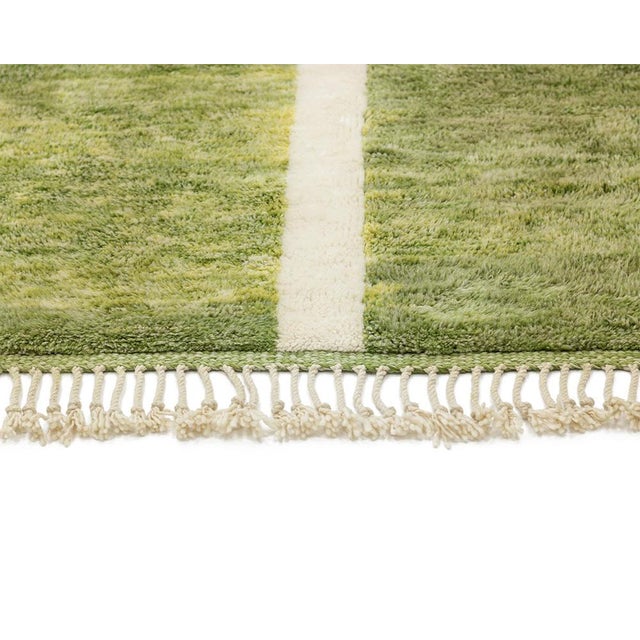 Vibrant hand-knotted wool rug with a gradient Greenfield and a striking ivory path design create a serene, nature-inspired...