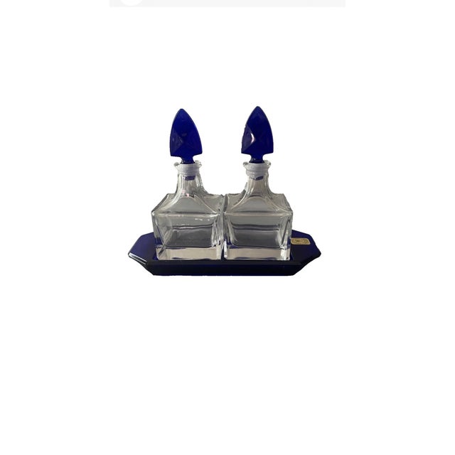 Beautiful vintage Nachtmann crystal perfume decanter set featuring two clear crystal bottles with striking sapphire blue...