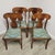 A beautifully crafted set of four mid-century dining chairs blending Georgian and Queen Anne Revival silhouettes.. The...
