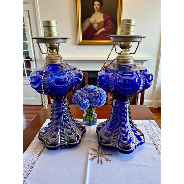 This pair of cobalt blue Coolidge drape oil lamps reflects the bold glasswork favored in American interiors during the...