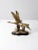 This is a vintage brass bird sculpture. Two birds soar across marshlands to shape this sculpture in brass with a black...