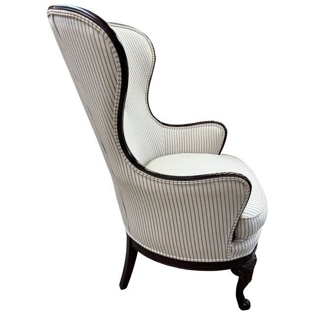 A blend of beauty and comfort. French style wing chair. Upholstered in a casual light blue pinstripe fabric. Perfect for...