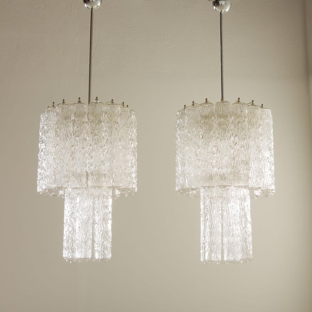 The pair of venini extra large chandeliers, attributed to toni zuccheri, designed in italy during the 1970s, exemplifies...