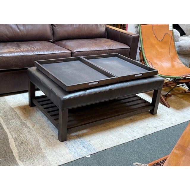 Design Plus Gallery presents a Kent Leather Ottoman + Pair of Trays from Arhaus. The ottoman is made from gray leather...