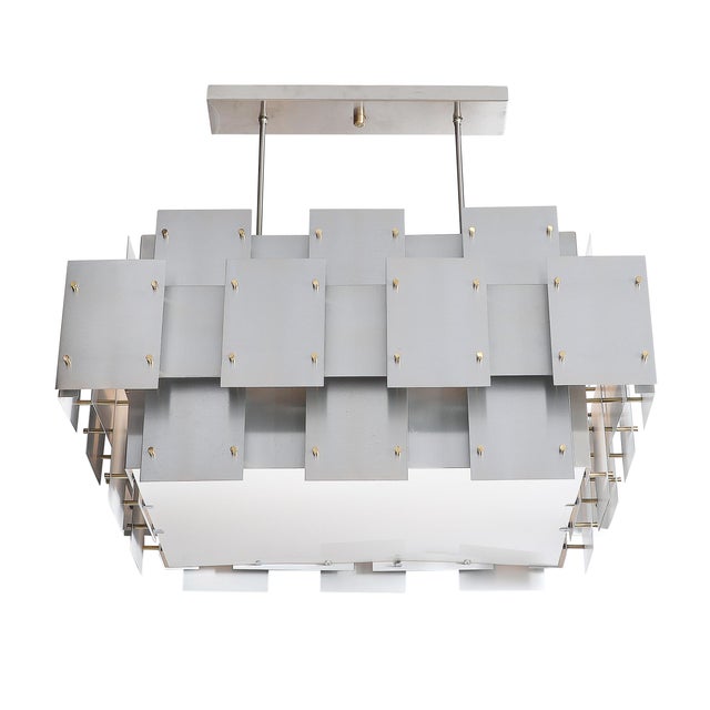 A bold and iconic design, this Mid-Century Modernist "Cityscape" chandelier by Robert Sonneman, created in America circa...