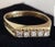 A refined modern british dress ring by h & t ltd, crafted in 14-carat yellow gold and claw-set with a brilliant-cut white...