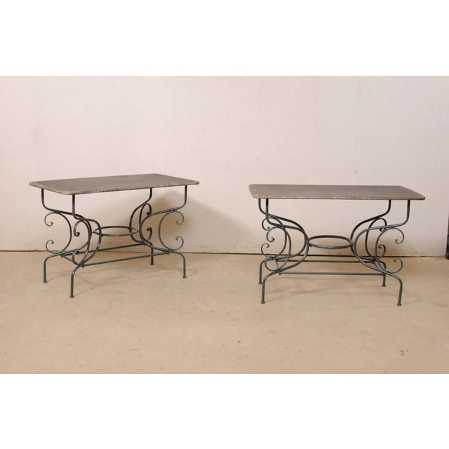A French pair of metal occasional tables from the mid 20th century. This vintage pair of tables from France each feature...