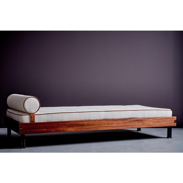 French daybed from the 1950s, defined by a clear, architectural mahogany frame and a refined sense of proportion. Newly...