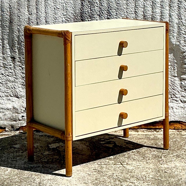 Add a touch of bohemian charm and functionality to your space with this Vintage Boho Rattan and Laminate Chest of Drawers....
