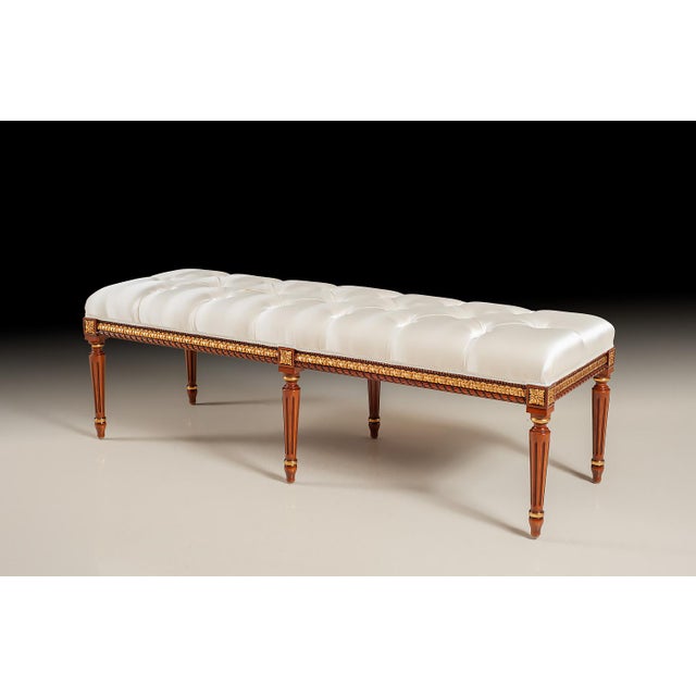 Handcrafted in Italy, this bench features elegant carving accents finished in 24-karat gold leaf. The tufted seat is...