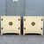 Elegant pair of vintage Chinoiserie server cabinets featuring warm cream finishes accented with fine gold detailing and...