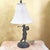 A vintage Bombay Company table lamp featuring a finely detailed metal sculpture of a golfer in mid-swing, finished in a...