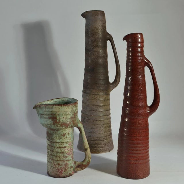 Rare group of six whimsical jugs / vases with long downward ears in various heights with earth tone glazes. They are like...