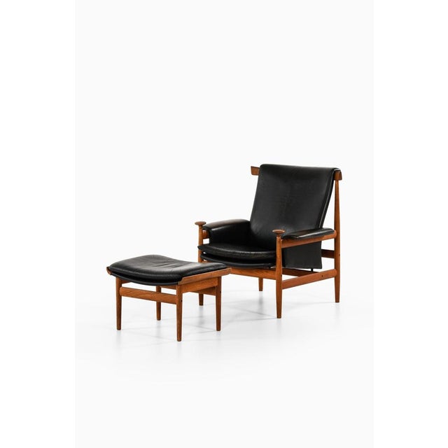 Easy chair with stool in teak and black leather by finn juhl, 1960's additional information: material: teak and black...
