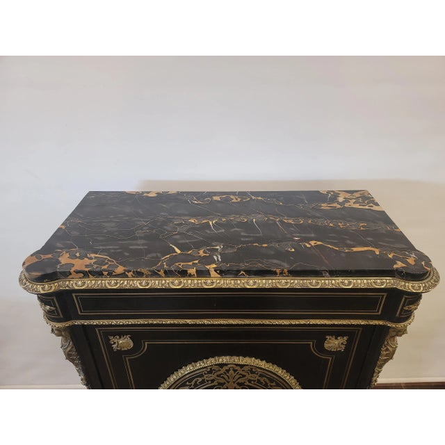 Here is a very nice Antique French Napoleon III Boulle Commode with Ebonized wood with ormolu details. The key and lock...