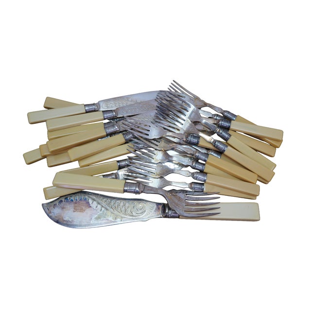 Antique Victorian fish cutlery serving set featuring silverplate construction with celluloid / bakelite handles. Includes...
