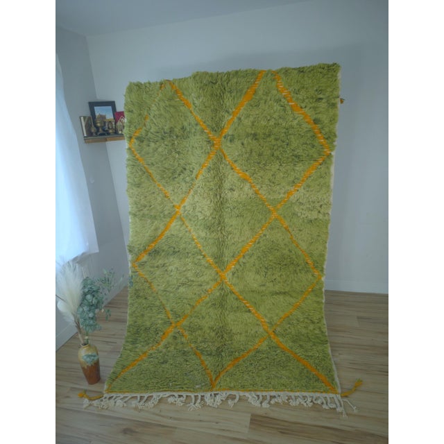 A high-energy contemporary Moroccan rug hand-knotted in wool on a cotton warp. A vivid lime-green shag pile is crossed by...