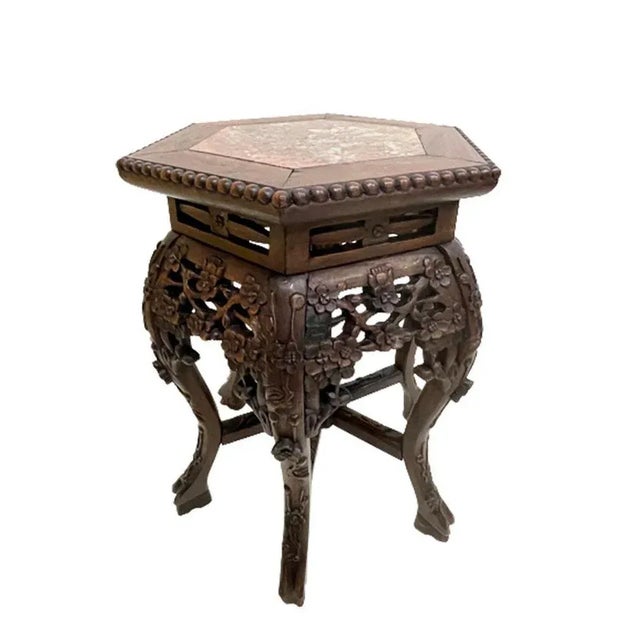 A Chinese 19th century side table or plant stand with marble top. A hexagonal top and round shape, bent legs underneath...