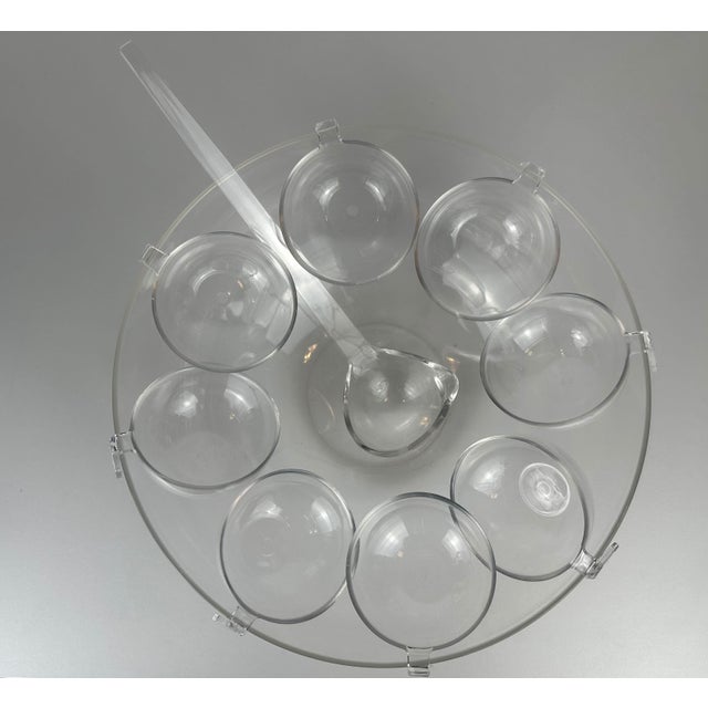 Vintage Guzzini punch bowl set. Transparent acrylic. The set consists of a large bowl, a ladle, and 8 cups. The cups can...