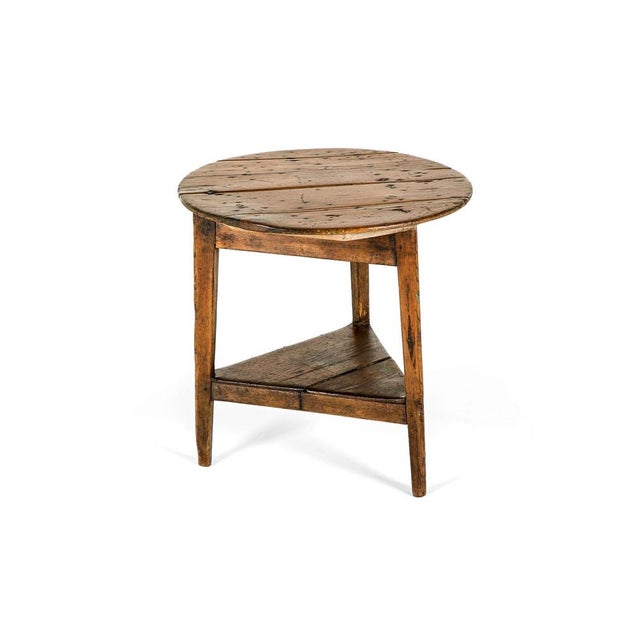 A superb early 19th-century cricket table of excellent form. Circular pine plank top over a triangular tier base on three...