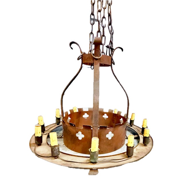 Vintage large round iron quatrefoil chandelier with twelve electric candle lights. Large outer ring has twelve electric...