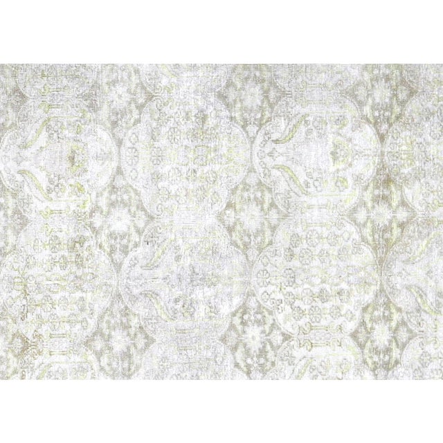 A vintage Turkish Oushak measuring 6'3" x 9'9", hand-woven with wool on wool foundation. This piece displays the region's...