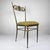 A rare pair of Italian mid-century Chiavari chairs featuring slender brass frames and elaborately decorated backs. The...