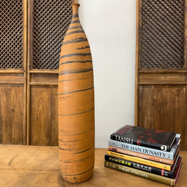 "About This Piece About This Piece Grand and commanding, this vase channels the rugged beauty of desert landscapes. Its...