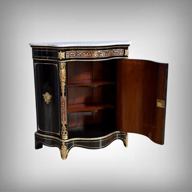 This sumptuous napoleon iii period piece, crafted from ebonized pearwood in the 19th century, pays homage to the...