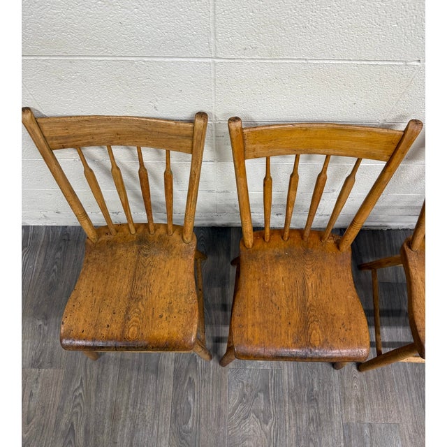 This is an amazing full set of four antique arrowback Windsor farmhouse plank seat dining chairs, like from between...