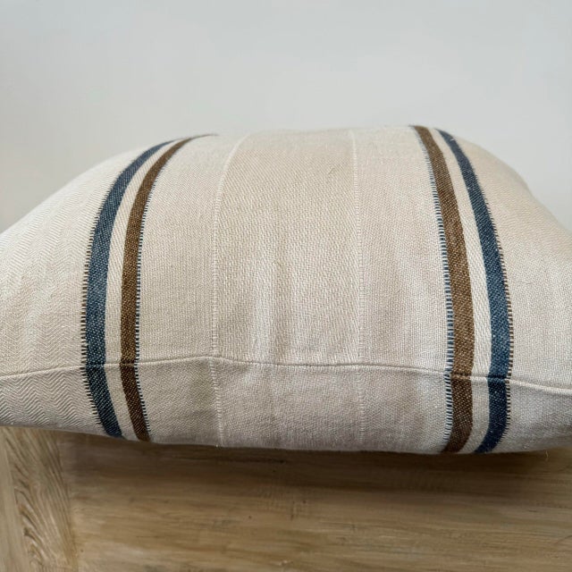 100% Belgian Linen. A beautiful natural pillow with bronze and navy stripes. This pillow has a soft texture. Color: Ecru...