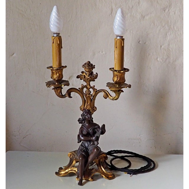 The candelabra features beautifully detailed scrolling arms, foliage, floral decoration and a decorative central finial....