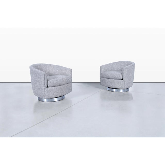 Pair of Milo Baughman for Thayer Coggin chrome swivel lounge chairs showcasing the designer's iconic blend of sculptural...