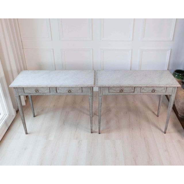 A refined pair of 19th-century Swedish Gustavian console tables, distinguished by their elegant proportions and restrained...