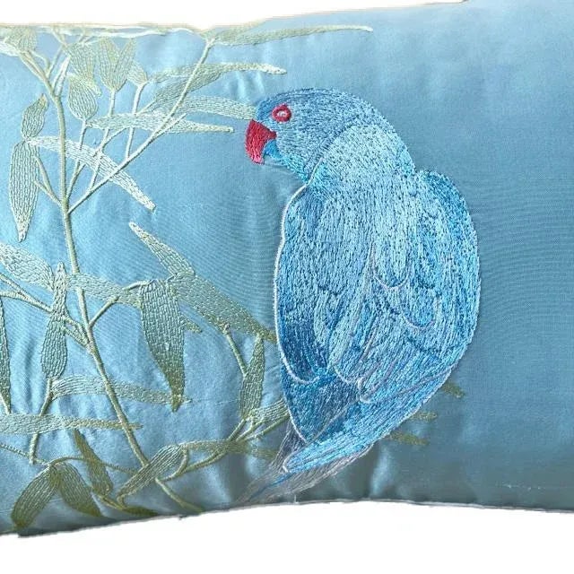 This dear little red-beaked parrot perched on a graceful bamboo branch is thought to promote calm. The elegant lumbar...