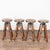 Set of four 20th century industrial barstools, crafted in pine with visible knots and natural wood grain throughout. Metal...
