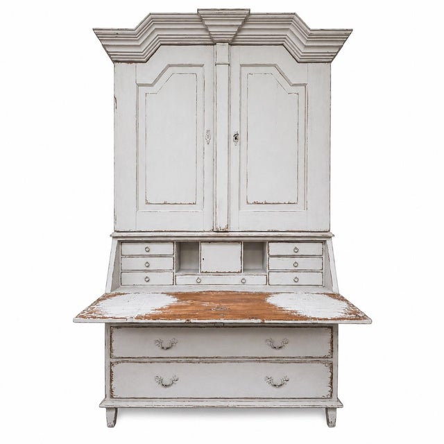 A beautiful antique Gustavian secretary showcasing the understated elegance and refined craftsmanship that define classic...