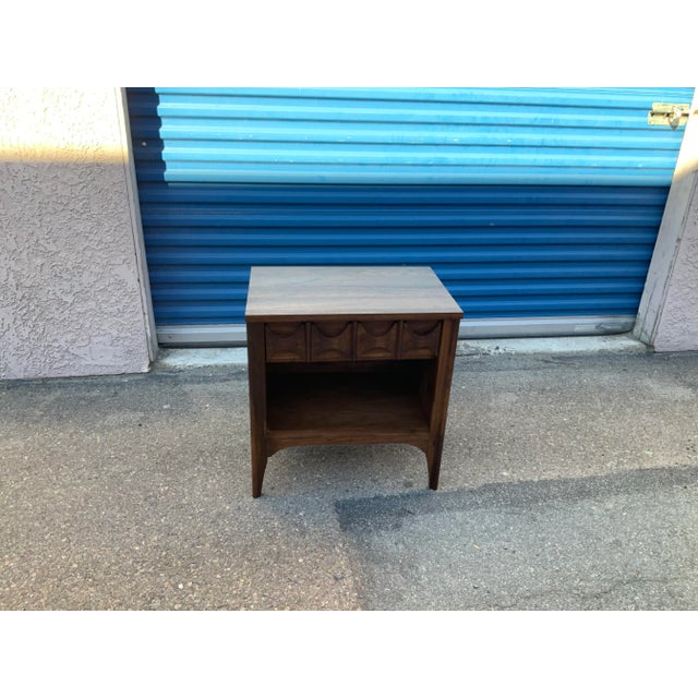 Stunning solid walnut mid century night stand. The piece is has 1 drawer and a shelf. The modern mid century stand is well...