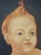 Oil on panel portrait of a young child, signed Strelecki at lower right. Executed in a restrained, folk-influenced style...