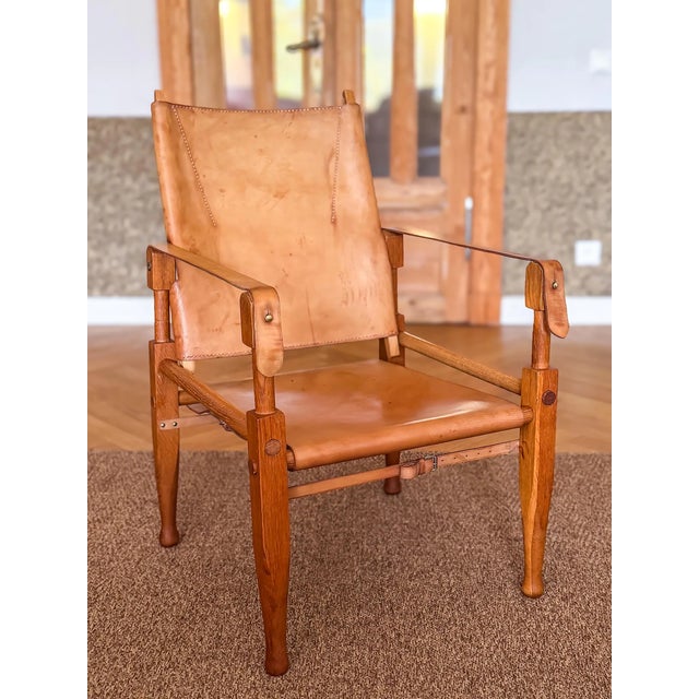 One wonderful natural dark oak wood safari chair, designed by Wilhelm Kienzle / Kare Klint, in 1928 for Wohnbedarf and...