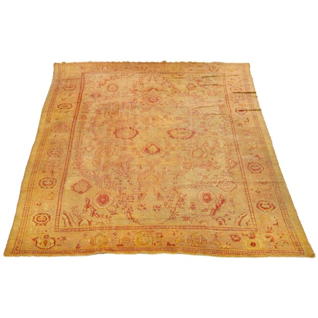 This exceptional antique Turkish wool rug has a charming tan-colored base and is hand-knotted with meticulous attention to...